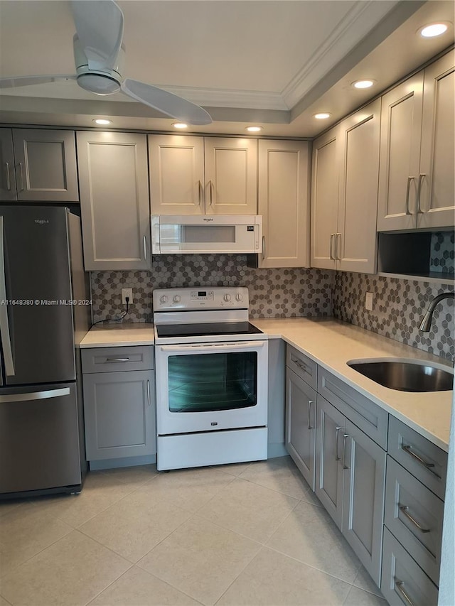 kitchen featuring tasteful backsplash, sink, crown molding, white appliances, and ceiling fan