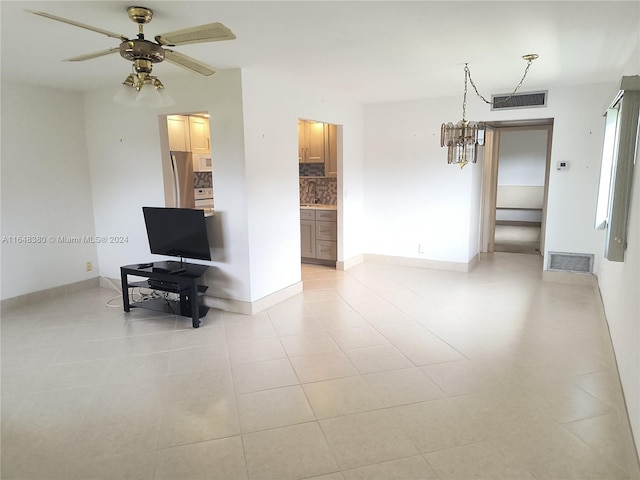 tiled living room with ceiling fan and sink