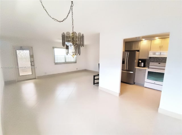 unfurnished dining area featuring an inviting chandelier