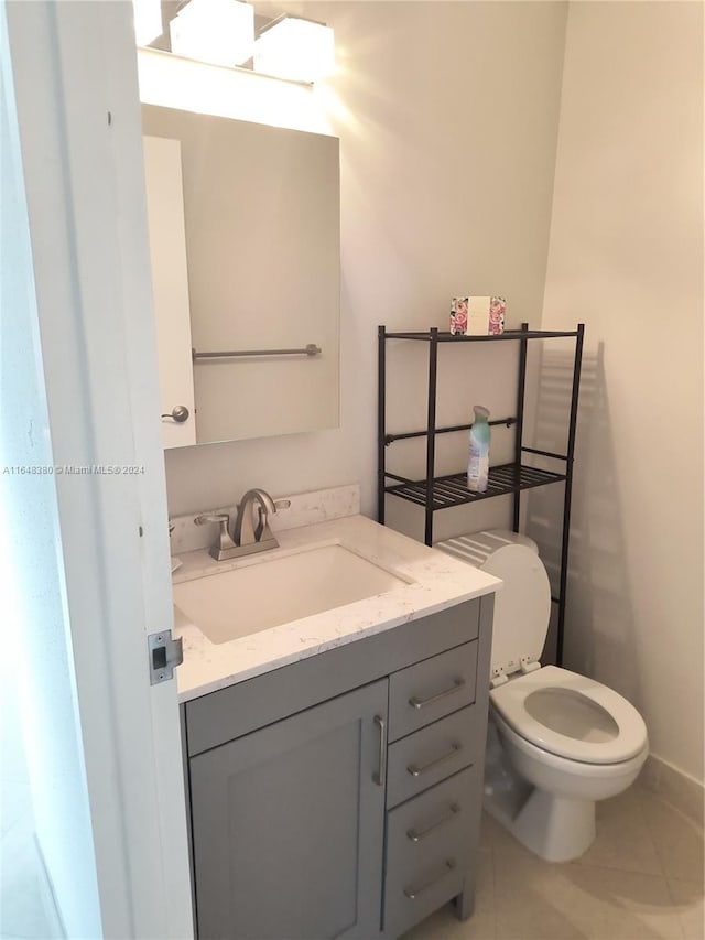 bathroom with tile patterned floors, toilet, and vanity