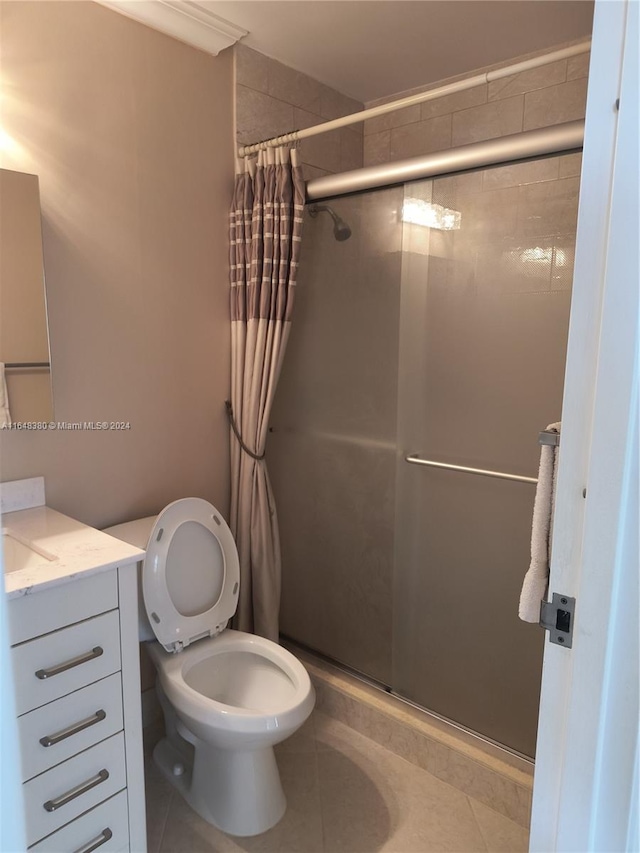 bathroom featuring toilet, walk in shower, tile patterned floors, and vanity