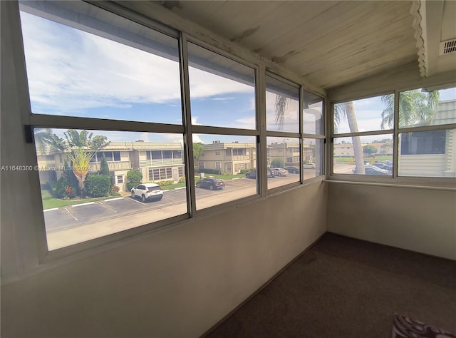 unfurnished sunroom featuring lofted ceiling