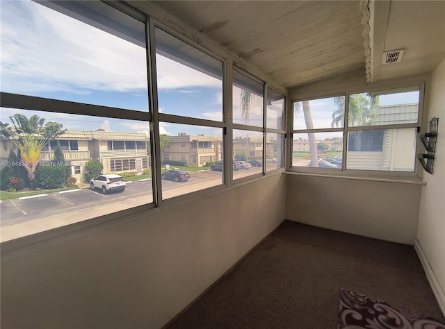 unfurnished sunroom with vaulted ceiling