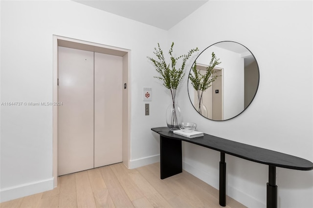 interior space featuring light hardwood / wood-style flooring and elevator