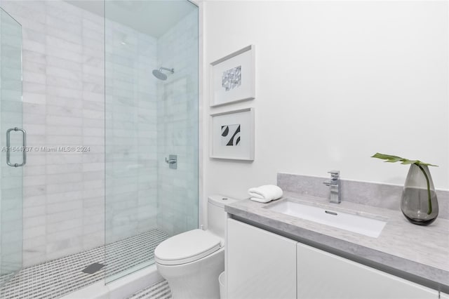 bathroom featuring vanity, toilet, and walk in shower