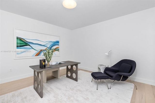 office space featuring baseboards and wood finished floors