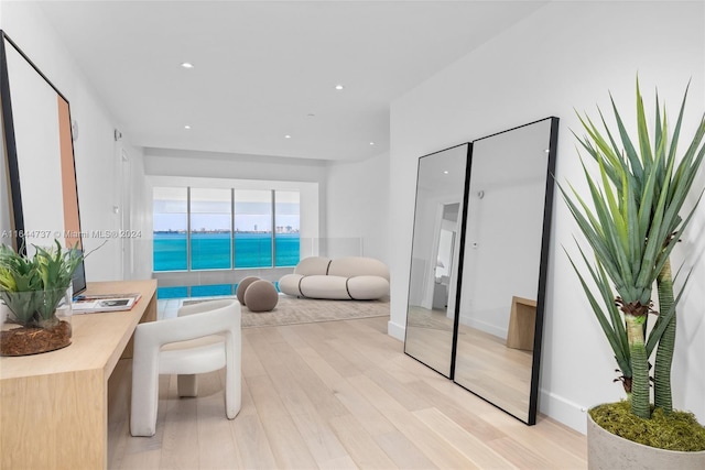 living room with recessed lighting, light wood-style flooring, and baseboards