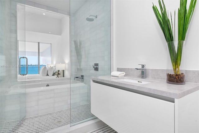 full bath with vanity, a bath, and a shower stall