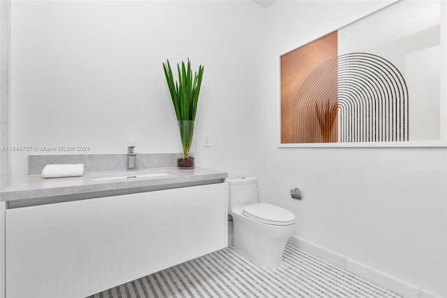 bathroom with tile patterned floors, toilet, and vanity