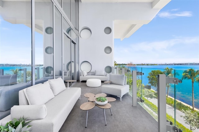 balcony featuring an outdoor living space and a water view