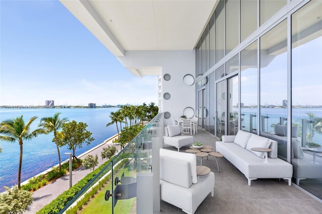 balcony with a water view and outdoor lounge area