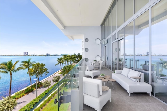 balcony with a water view and an outdoor living space