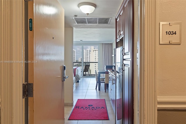 hall with light tile patterned floors