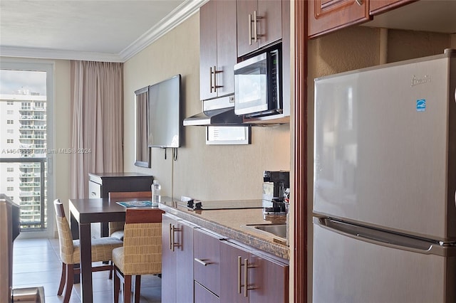 kitchen featuring ornamental molding, cooktop, fridge, and tile patterned floors