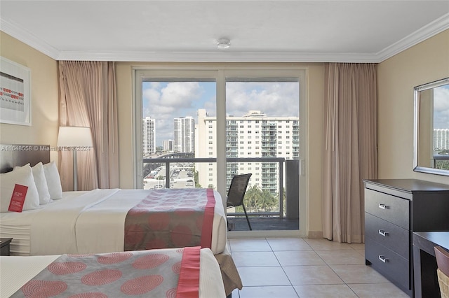 tiled bedroom featuring ornamental molding, multiple windows, and access to outside