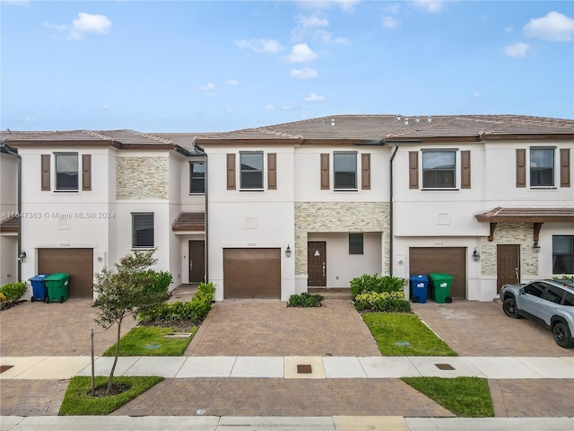 multi unit property featuring a garage