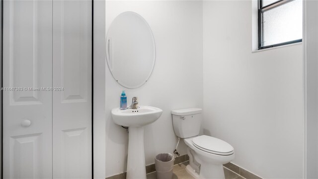 bathroom with tile patterned flooring and toilet