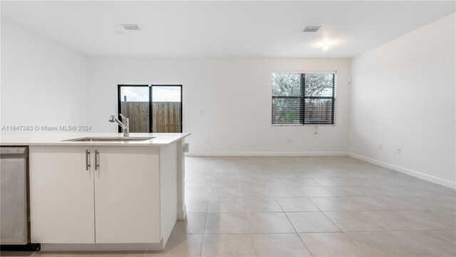 kitchen with sink, light tile patterned flooring, and dishwasher