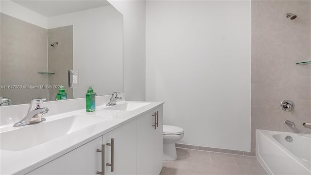 full bathroom with tiled shower / bath combo, tile patterned floors, toilet, and vanity