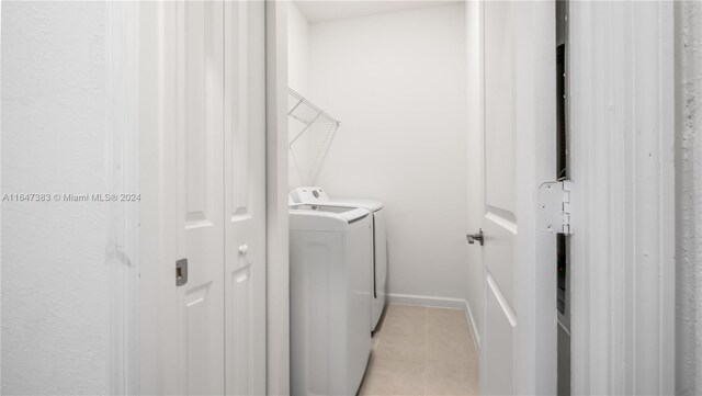 laundry room with light tile patterned floors and washer and dryer