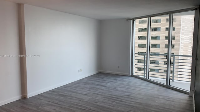 unfurnished room with hardwood / wood-style flooring