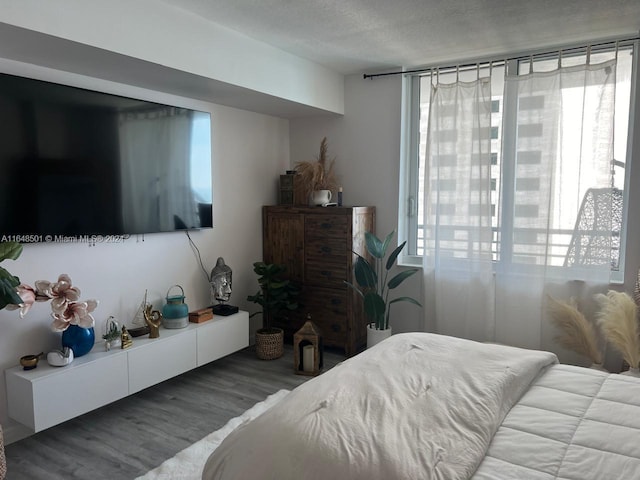 bedroom with wood-type flooring and a textured ceiling