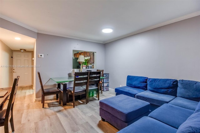 living room with crown molding and light hardwood / wood-style floors