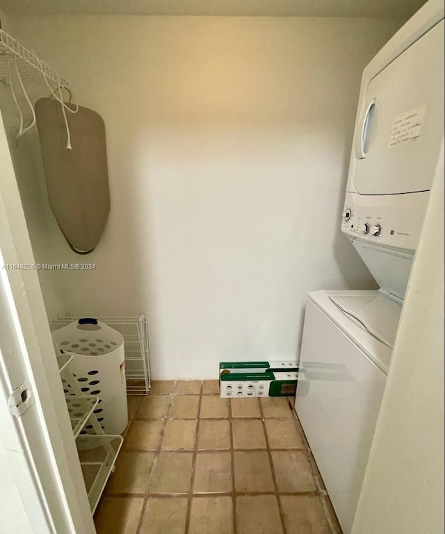 laundry room with stacked washer and dryer and laundry area