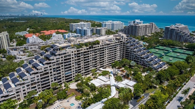 birds eye view of property with a water view and a view of city