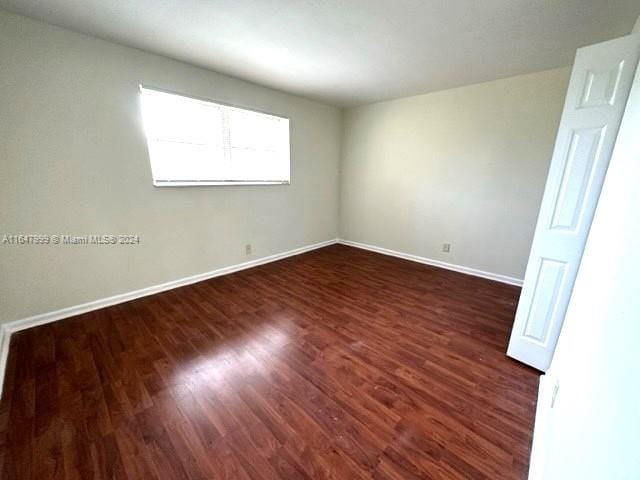 empty room featuring dark hardwood / wood-style flooring