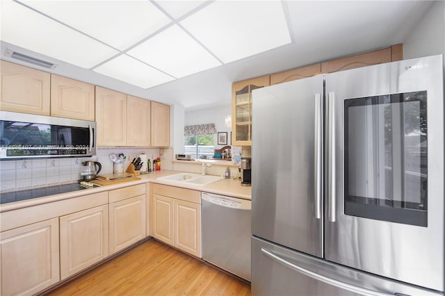 kitchen featuring visible vents, appliances with stainless steel finishes, light countertops, light brown cabinets, and a sink