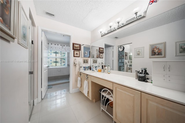 full bath with tile patterned flooring, visible vents, a textured ceiling, and vanity