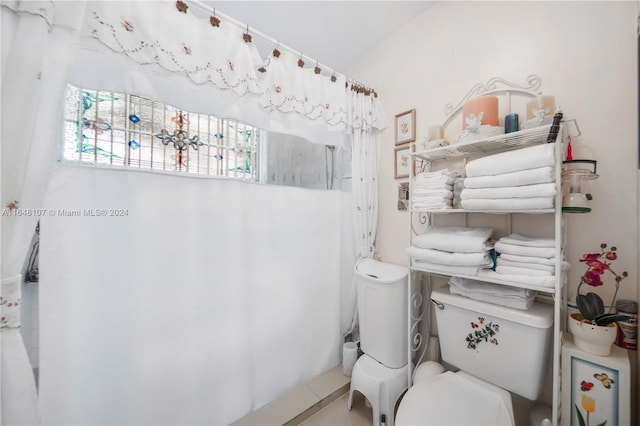 bathroom with tile patterned flooring and toilet