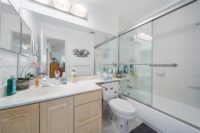 bathroom with toilet, combined bath / shower with glass door, visible vents, and vanity