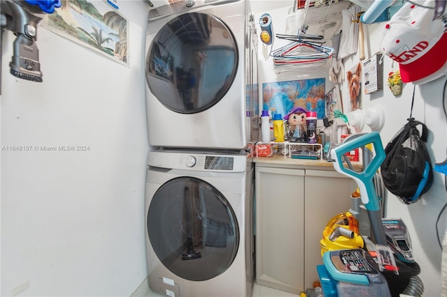 laundry area featuring stacked washer / drying machine and laundry area