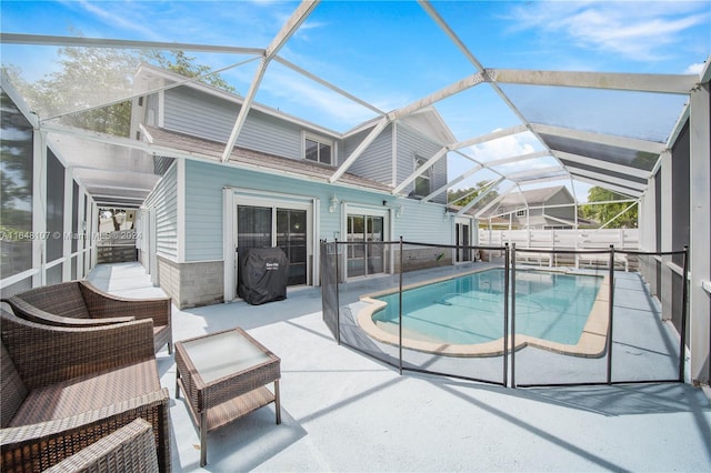 view of pool with a fenced in pool, glass enclosure, a patio, and fence