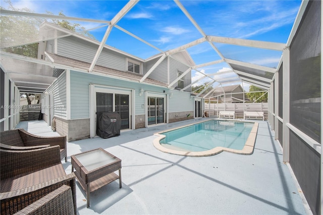 view of swimming pool with a fenced in pool, a lanai, and a patio