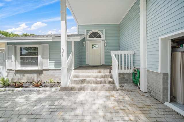 property entrance featuring brick siding