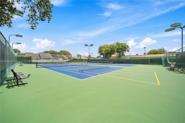 view of tennis court with fence