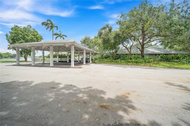 view of property's community with a carport and a water view