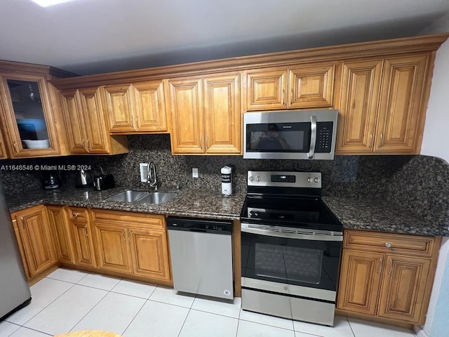 kitchen featuring light tile patterned flooring, stainless steel appliances, and tasteful backsplash