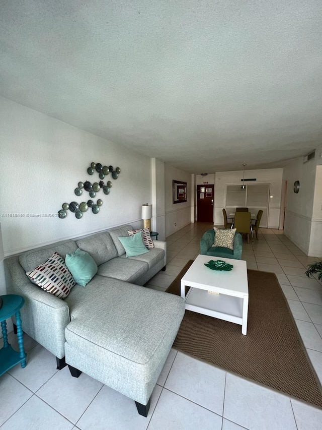 living room with tile patterned flooring and a textured ceiling