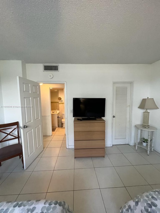 tiled living room with a textured ceiling