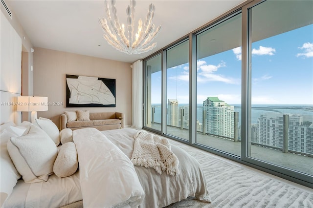 bedroom with floor to ceiling windows, an inviting chandelier, access to outside, and multiple windows