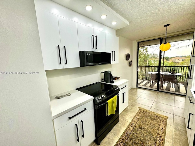 kitchen with light tile patterned floors, white cabinets, pendant lighting, and black appliances