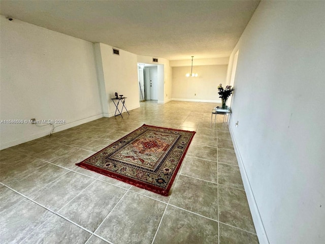 interior space with a textured ceiling and tile patterned floors