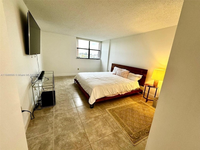 tiled bedroom with a textured ceiling