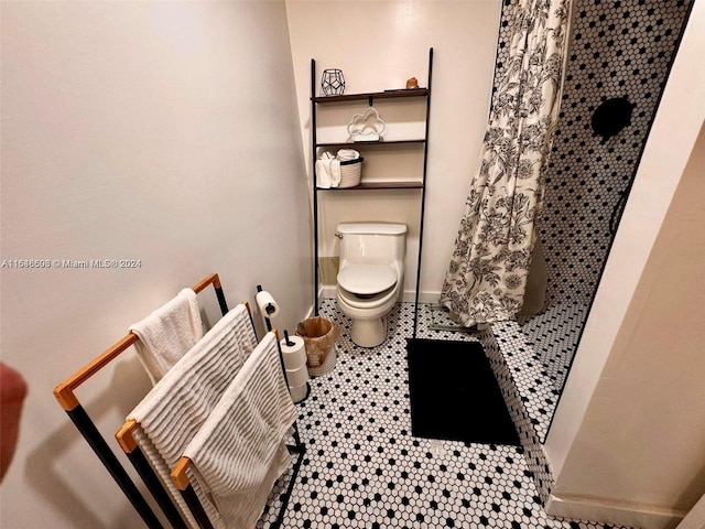 bathroom featuring toilet, tile patterned flooring, and curtained shower