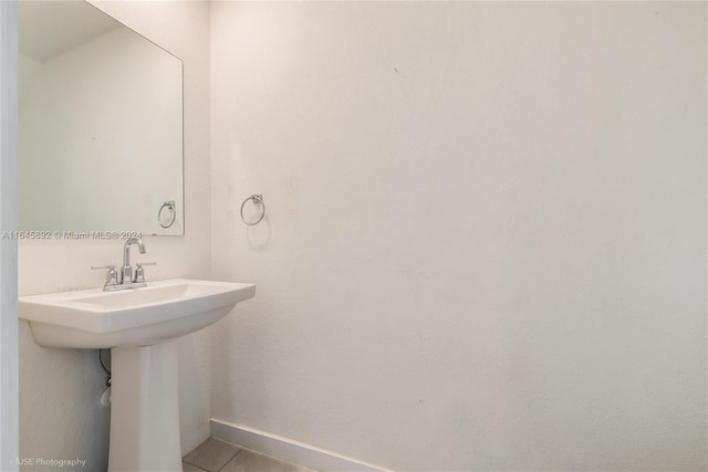 bathroom with tile patterned flooring and baseboards