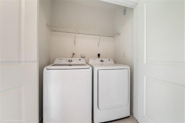 washroom with washing machine and dryer and laundry area